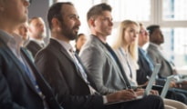 corporate event guests sit during a lecture