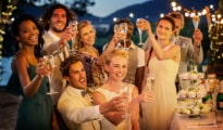 wedding guests smile and make a toast